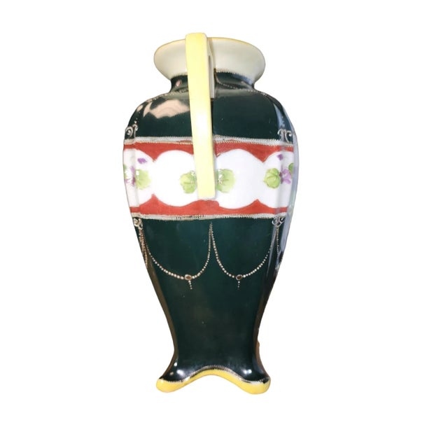 Rare example Japanese export polychrome handpainted molded porcelain vase with twin handles, four formed feet, decorated...
