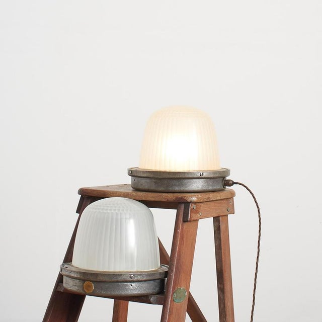Originally a street lamp from the parisian streets, the lamp has a cast metal base and prismatic glass shade. The light...