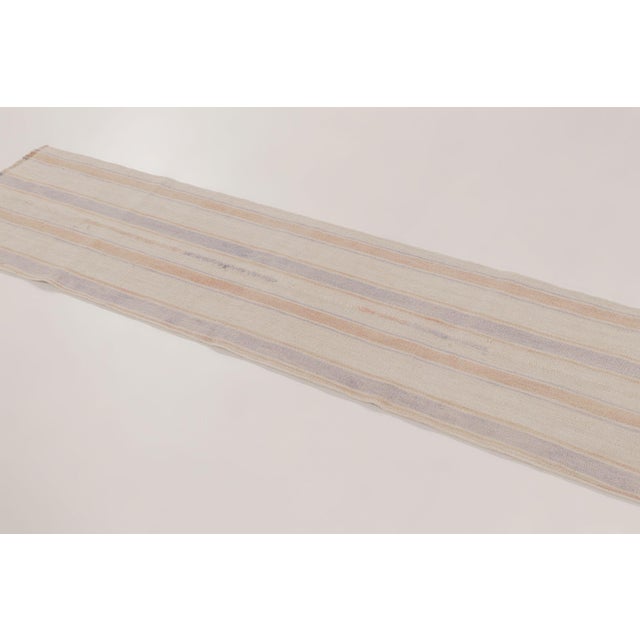 Handwoven in hemp, this 2x7 modern kilim runner is a sophisticated addition to Rug & Kilim’s collection, reflecting a...