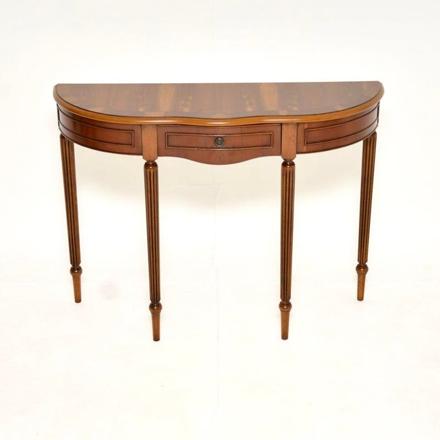 A fine and elegant antique Regency style yew wood console table. This was made in England, it dates from around the...