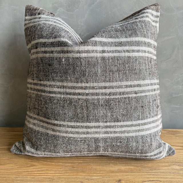 Creamy white hemp rug pillow with stripes. Soft hand, linen blend backing with zipper closure. Spot cleaning is...