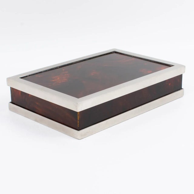 This elegant 1970s rectangular-shaped decorative lidded box was designed by the Parisian luxury house Maison Mercier. It...