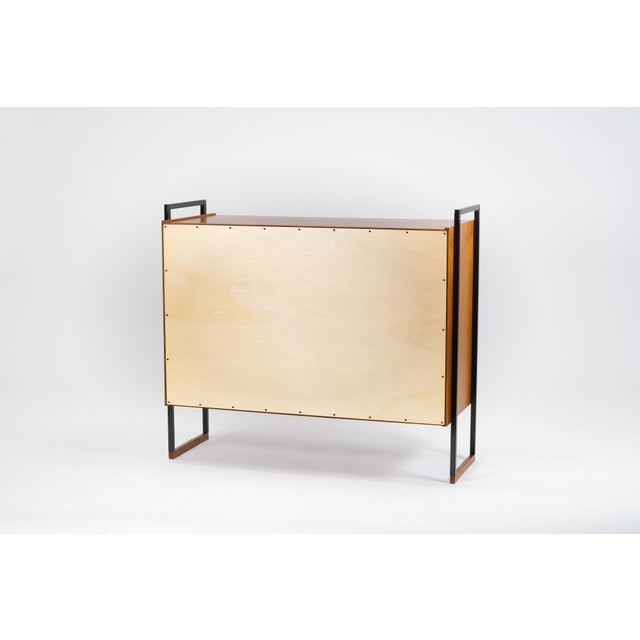 Classic and practical shoe cabinet from the 1950s/60s, made in Germany. The cubic body is made of beautiful teak veneer....
