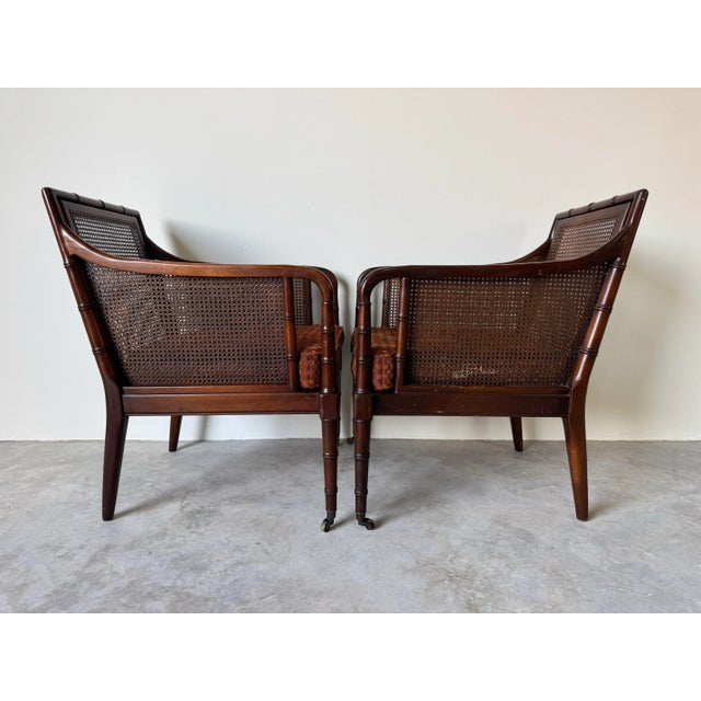 A charming pair of 1970’s Regency-style caned armchairs by Hickory Chair, beautifully crafted with faux bamboo carved...
