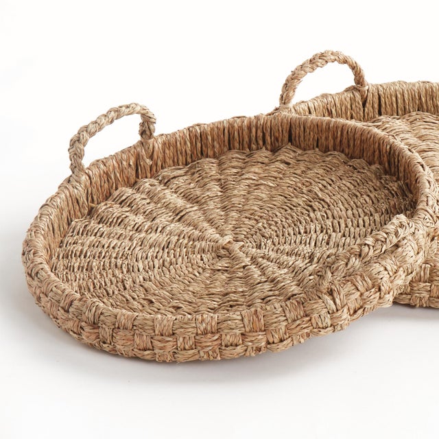 This set of 2 round trays with handles is light in tone, with a signature Mendong weave. Abundantly grown and sustainably...