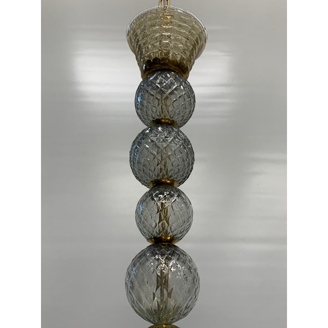 Murano glass chandelier made entirely by hand, characterized by a two-level composition with a central structure in...