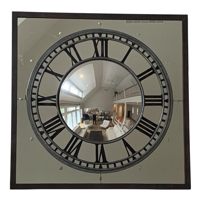 Restoration Hardware’s oversized iron framed wall mirror with a convex center and clock-face painted in bold, decorative...