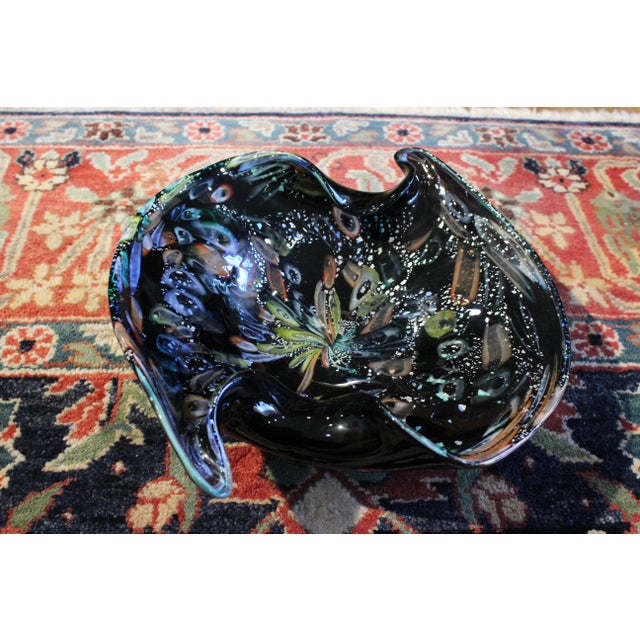 This is a beautiful decorative hand-blown glass centerpiece bowl attributed to Murano glass makers. The stunning tutti...