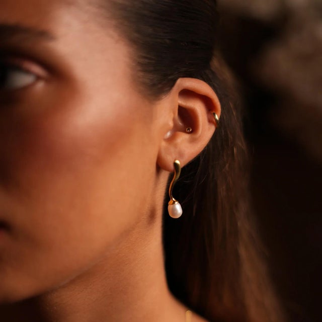 Gracefully designed with a wave shaped gold vermeil accent, these elegant earrings feature 18k gold plated on sterling...