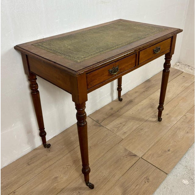 Elegant English Georgian style writing table crafted from solid wood with a warm oak-toned finish. The rectangular top...