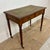Elegant English Georgian style writing table crafted from solid wood with a warm oak-toned finish. The rectangular top...