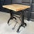 Turn of the 20th century, tall, industrial table features a japanned, cast iron machine base with brass-toned filigree...