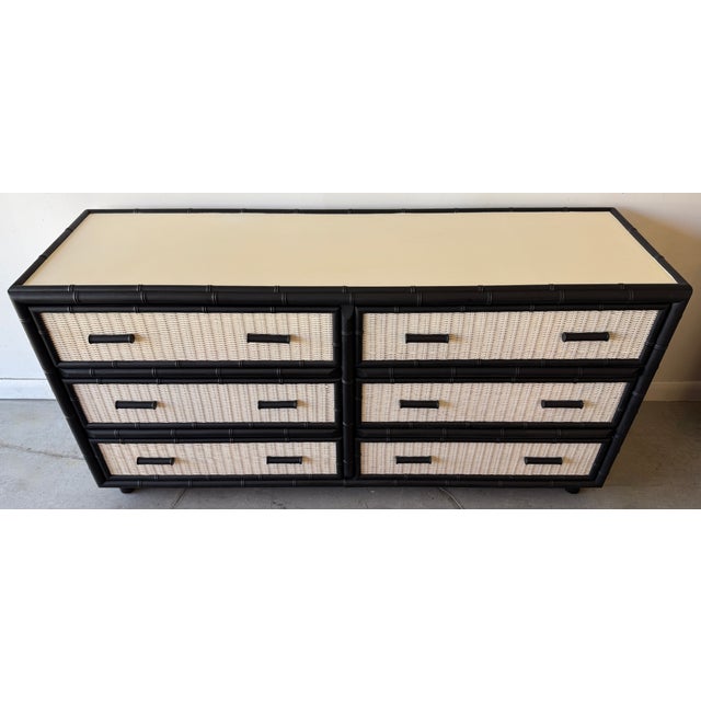 This piece is a vintage 6-drawer double dresser showcasing a striking Hollywood Regency or British Colonial aesthetic. It...