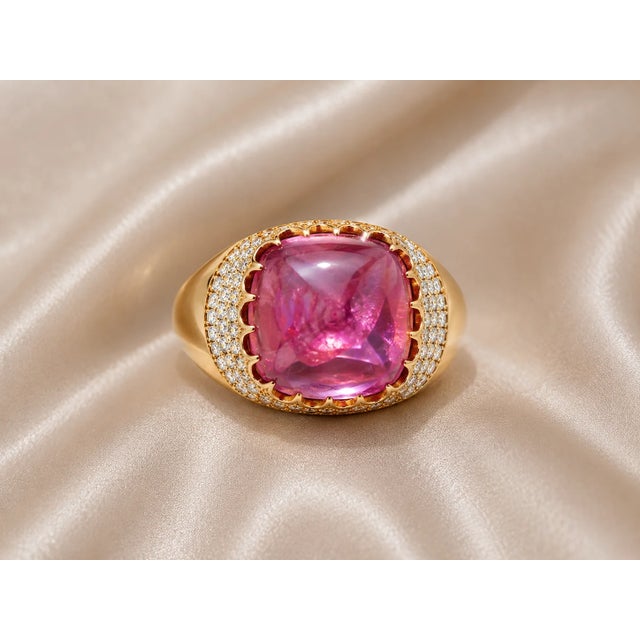 14K pink gold ring featuring a large natural cabochon amethyst (18.03 carats) surrounded by diamonds totaling 0.65 carats....
