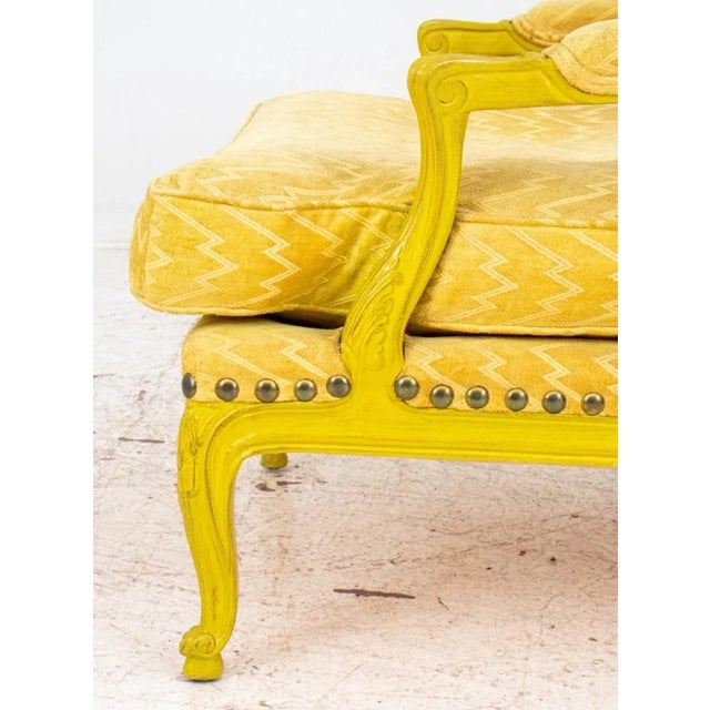 French Louis XV style yellow painted wood lounge armchair or 'chauffeuse', raised on cabriole legs with carved floral...