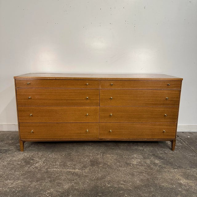 Mid century modern Paul McCobb for Calvin Dresser Chest of Drawers. This dresser has 8 pull out drawers with brass knobs....