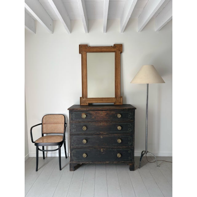 A large scale French wall mirror in limed oak with geometric detailing, dating from the early 20th century. Handmade in...