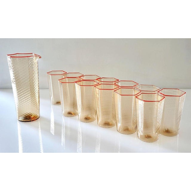 Elegant set of 12 handmade Murano glass with a matching jug in warm amber fume color. Each piece is decorated with the...