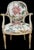 This is a lovely neo-classical style arm chair with an ivory painted frame and gilt accents. The vibrant floral upholstery...