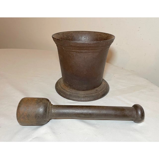 Up for sale is a very large antique early 19th century handmade cast iron mortar and pestle. This rare example features a...