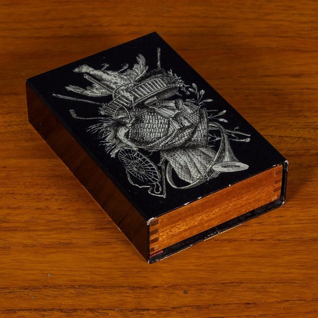 A delightful glove box or trinket box by Piero Fornasetti, circa 1960s / 1970s, with sliding cedar interior, bearing the...