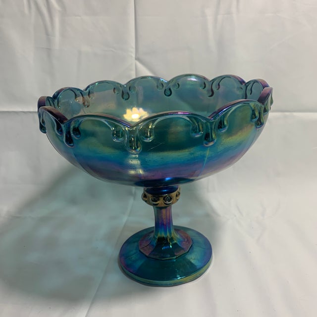 This vintage Indiana Glass iridescent blue carnival glass pedestal compote features the classic teardrop garland pattern...
