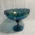 This vintage Indiana Glass iridescent blue carnival glass pedestal compote features the classic teardrop garland pattern...
