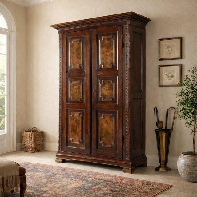 Walnut wardrobe. The front features two tripartite doors with walnut burl panels applied as later embellishments. The...