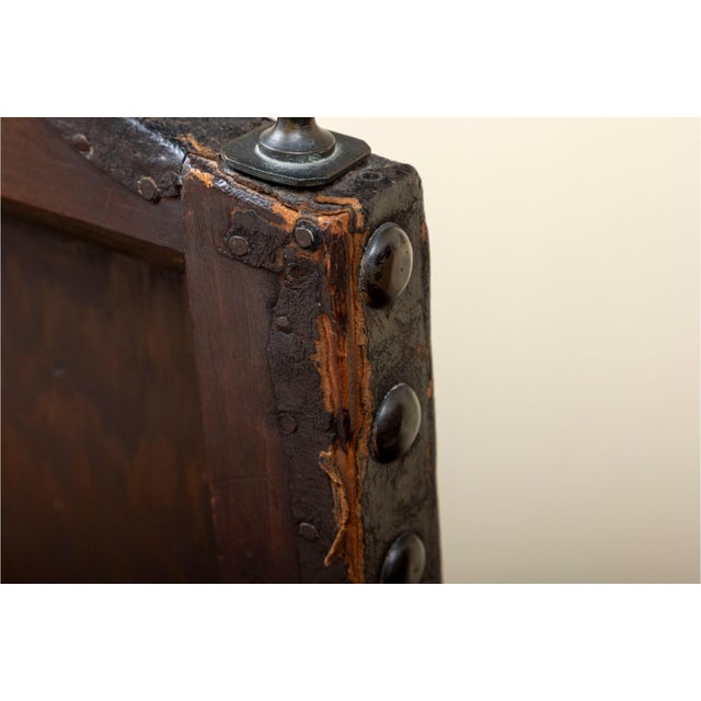 A gorgeous antique Jacobean throne chair with Spanish baroque appeal, featuring a medium-dark brown frame with hand-tooled...