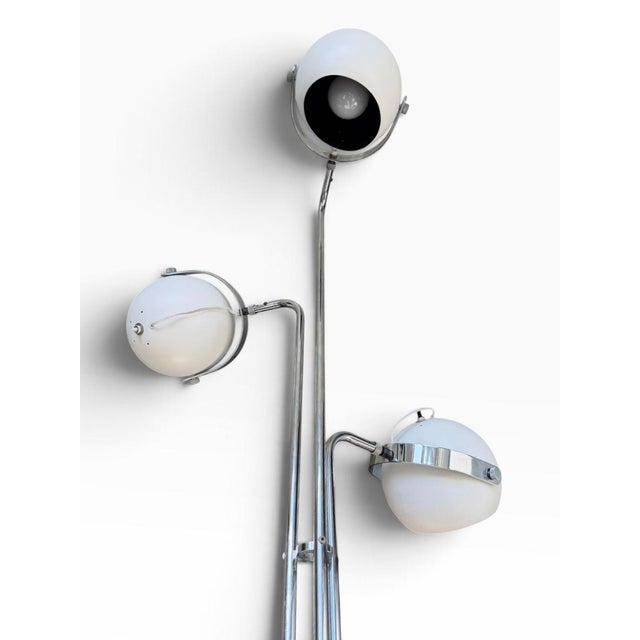 Robert Sonneman three-arm eyeball floor lamp, 1970s. Polished chrome stems and arms with white enameled ball shades on a...