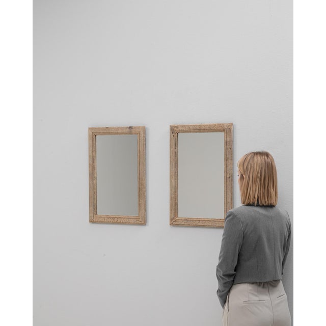 This pair of 1900s French oak wall mirrors offers a simple, timeless aesthetic rooted in traditional craftsmanship. Each...