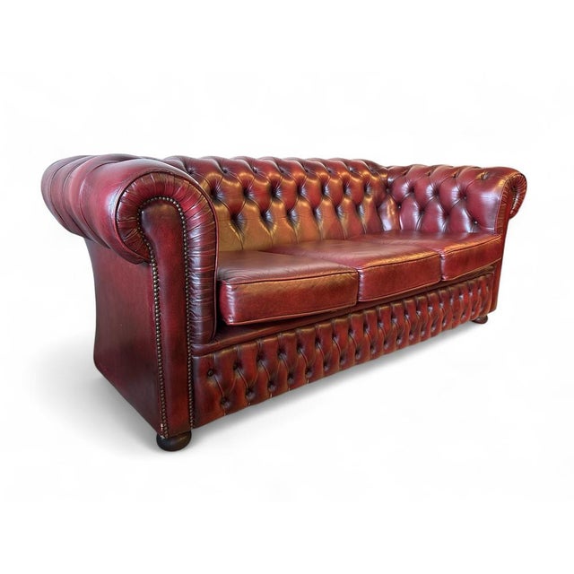 Vintage Chesterfield sofa upholstered in burgundy leather with a beautiful natural patina. Crafted in the late 20th...
