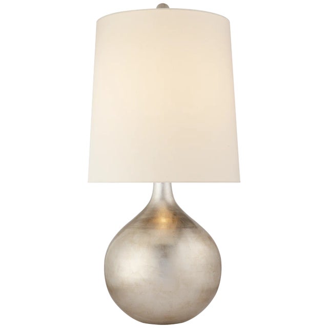 Warren Table Lamp in Burnished Silver Leaf with Linen Shade Designer: AERIN Height: 32.5" Shade Detail: 15" x 17" x 17.5"...