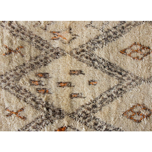 A chic and bold mid-20th century Moroccan rug with an all-over geometric partner including large and small diamonds on one...