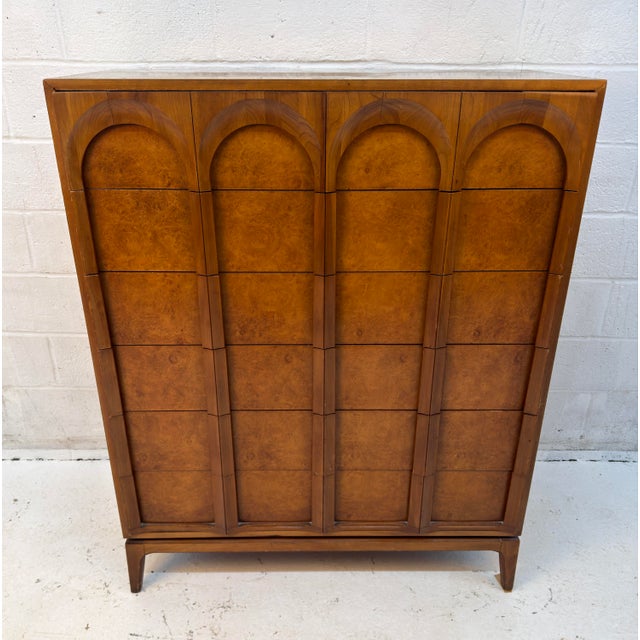 Striking mid-century modern highboy dresser by Thomasville, featuring a sculptural silhouette, rich walnut finish, and...