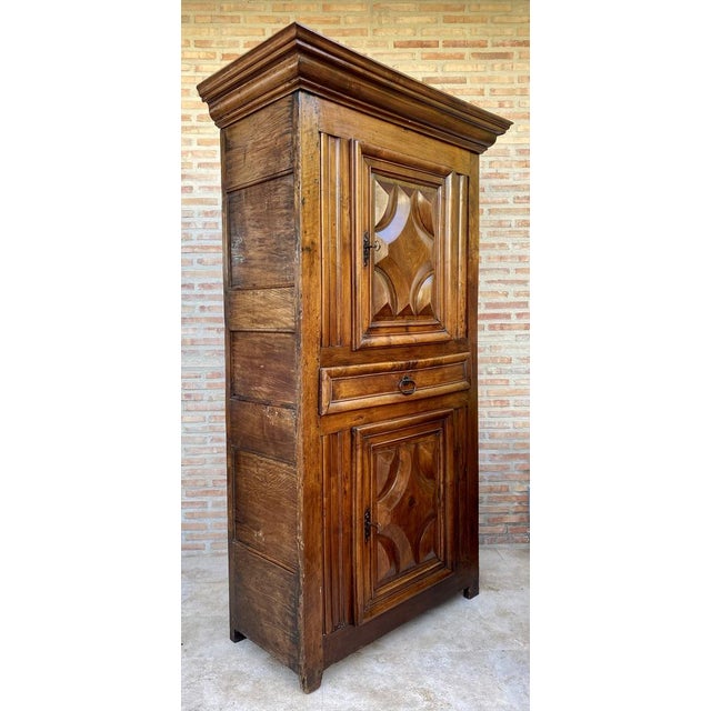 An exquisite Dutch cushion cabinet with two doors. This closet owes its name to the pillow-shaped reinforcements on the...