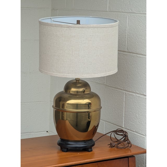 Vintage brass ginger jar lamp has rounded body with minimal, traditional detailing, creating a streamlined silhouette and...