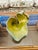 An expressive hand-built pottery sculpture featuring an organic, free-form silhouette with flowing, undulating edges....