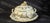 A painted and gilt porcelain tureen, with its matching stand, by le tallec, paris. the set features a decoration of gilt...