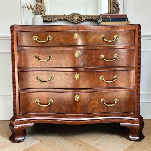 Beautifully figured bookmatched walnut veneer, graceful bow-front curves, and stunning fretwork come together in this...