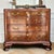 Beautifully figured bookmatched walnut veneer, graceful bow-front curves, and stunning fretwork come together in this...