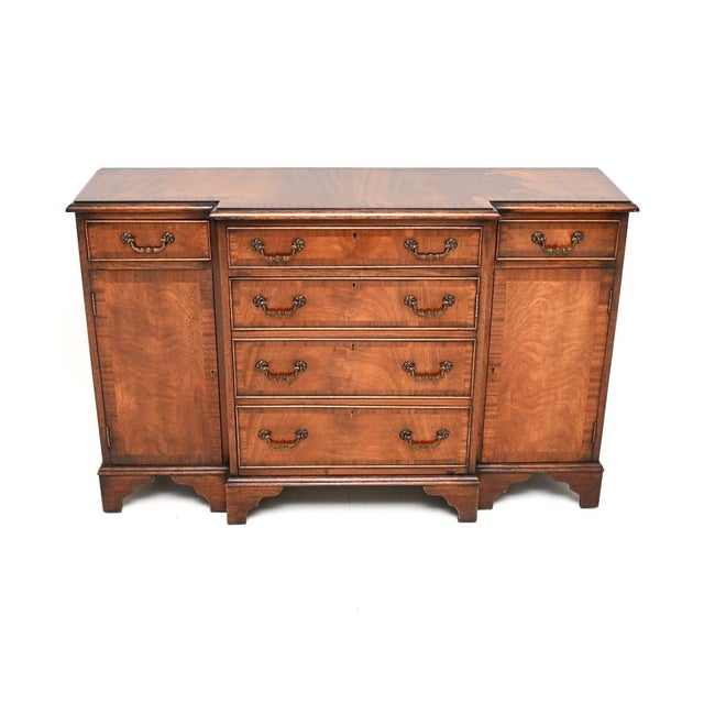 A compact and beautifully made antique Georgian style small breakfront sideboard. This was made in England, it dates from...