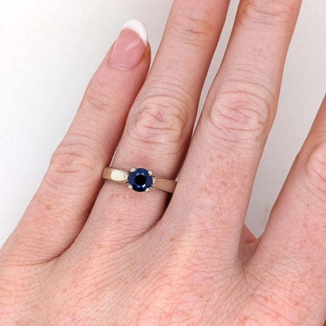 A blue sapphire glows in a rich blue at the centre of this solid 14K white gold ring. Sapphire's exceptional hardness,...