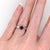 A blue sapphire glows in a rich blue at the centre of this solid 14K white gold ring. Sapphire's exceptional hardness,...