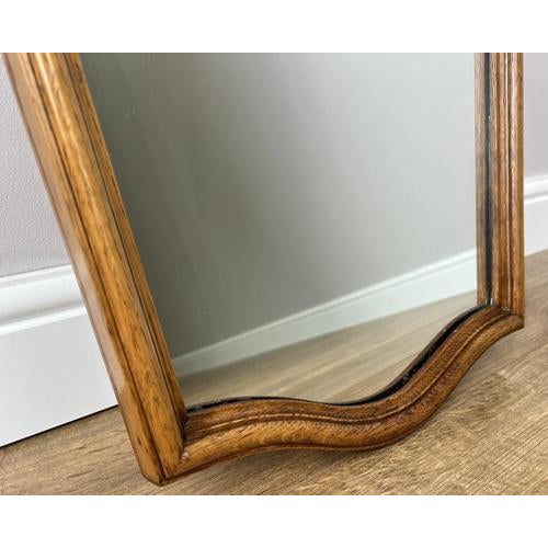 A beautifully shaped Vintage French Louis wall mirror, featuring an elegant carved frame with graceful curves and classic...