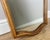 A beautifully shaped Vintage French Louis wall mirror, featuring an elegant carved frame with graceful curves and classic...