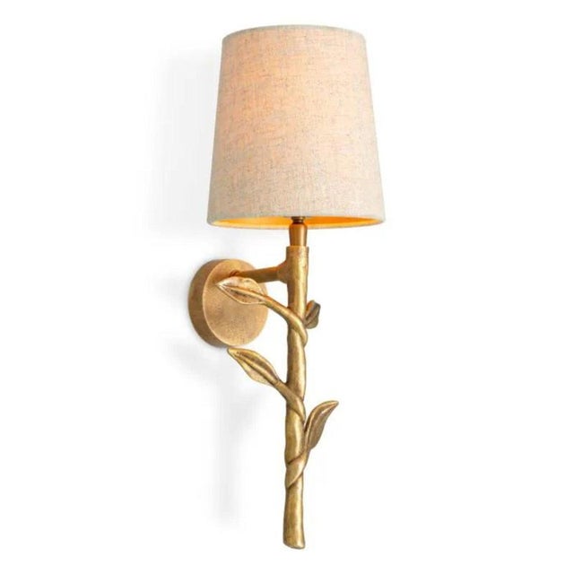 Pair of vintage brass wall lamp featuring a sculptural branching metal frame and a light linen-mix shade. The warm brass...