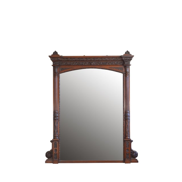 A monumental 19th century solid oak mirror, having foliage carved cavetto cornice with decorative carved bell shaped...