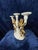 Exquisite Italian craftsmanship in this ornate candelabra! Warm golden angels wrap their delicate arms around white...