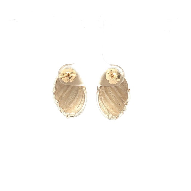 A striking pair of sterling silver and 14k gold drop earrings. These feature a twisted design with alternating silver and...